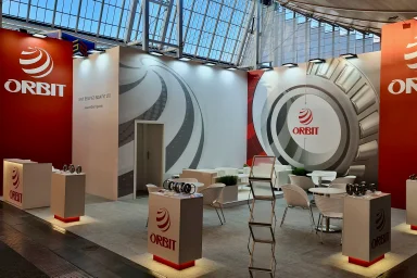 Exhibition stand with double-height branding tower