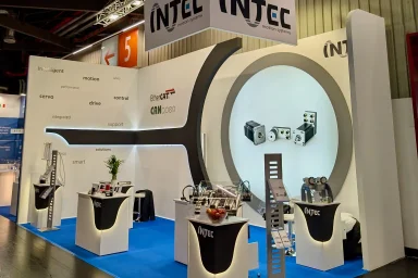 Exhibition stand with reception desk and branding wall